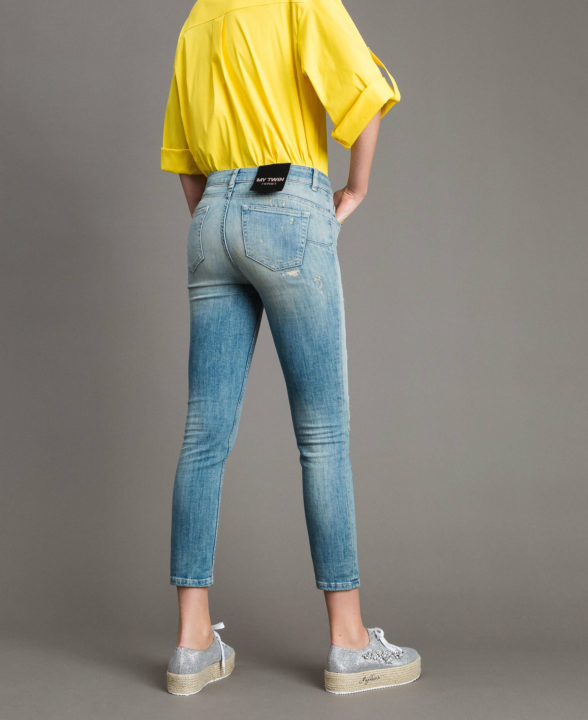 blue jeans with yellow rips