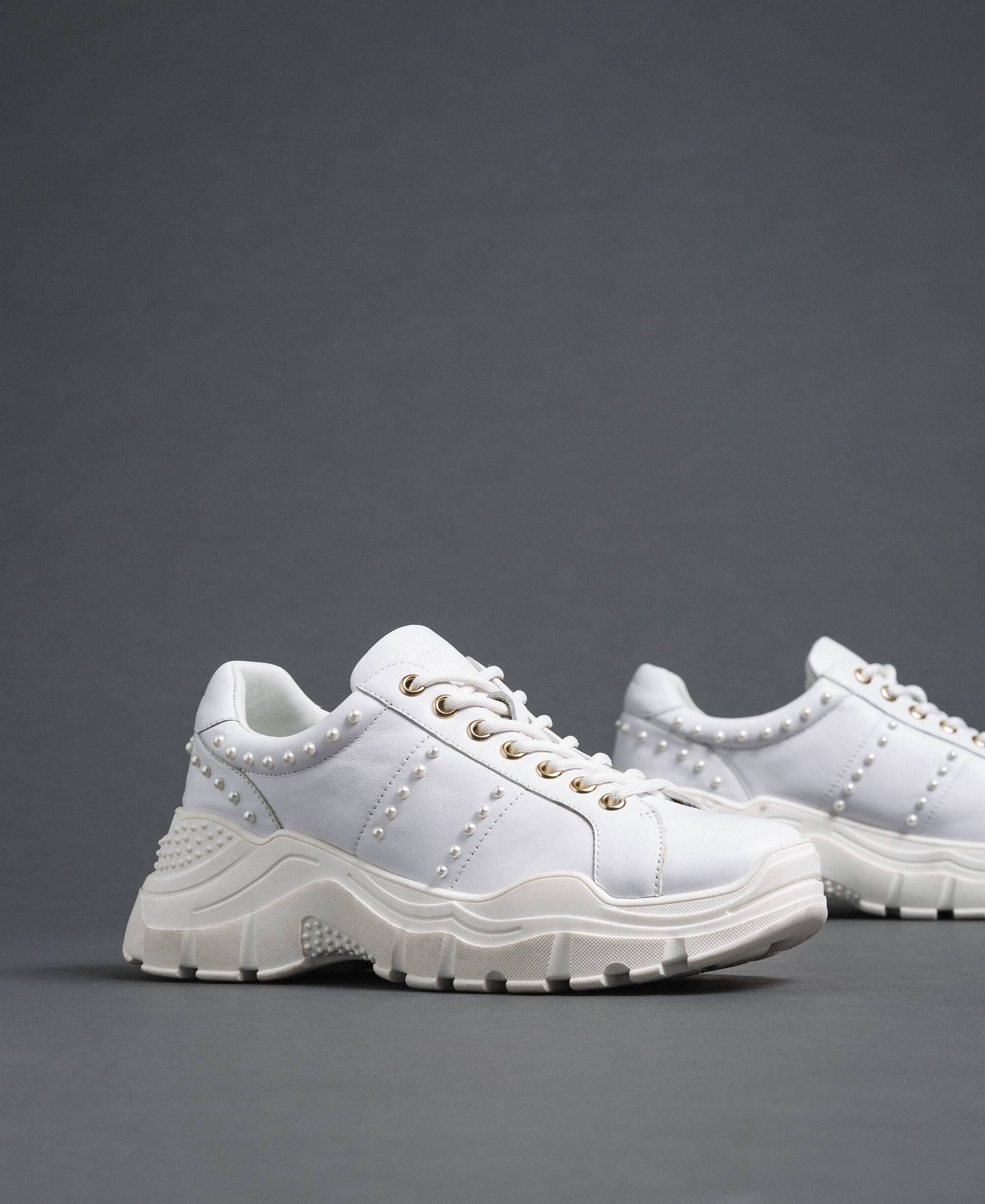 white leather running shoes